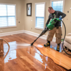 Professional Utah Flood Damage Company Employee extracting water from hardwood floors